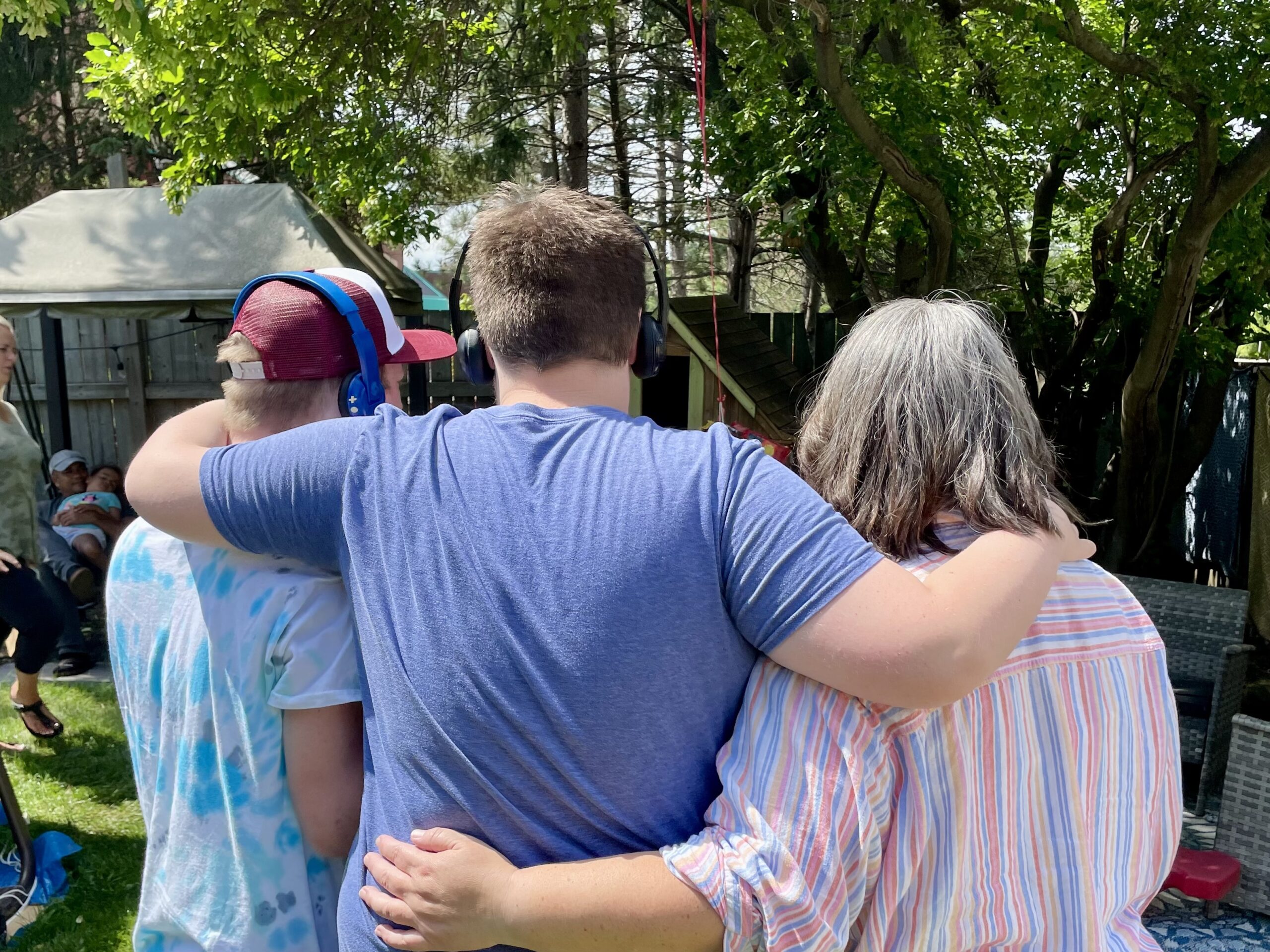 Future planning for autistic adults – single mom standing with adult sons in Ontario”